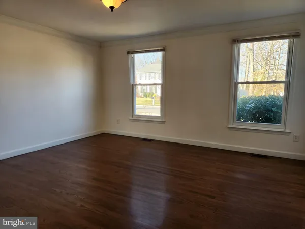 an empty room with wooden floor