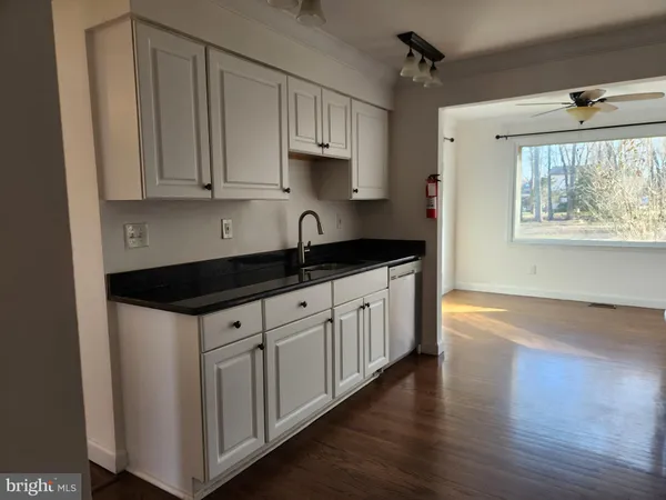 a kitchen with a sink a window and cabinets