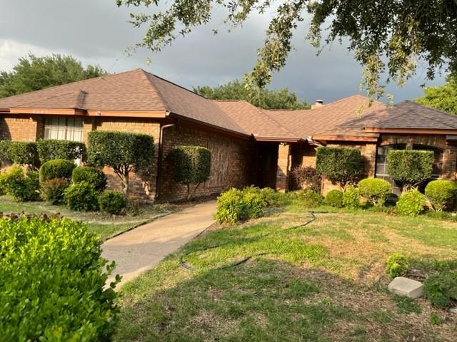 6305 Rising Meadow Drive Arlington, TX 76018 - Photo 1 of 1 a view of a white house with a big yard and potted plants