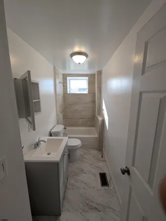 a bathroom with a sink a toilet and mirror