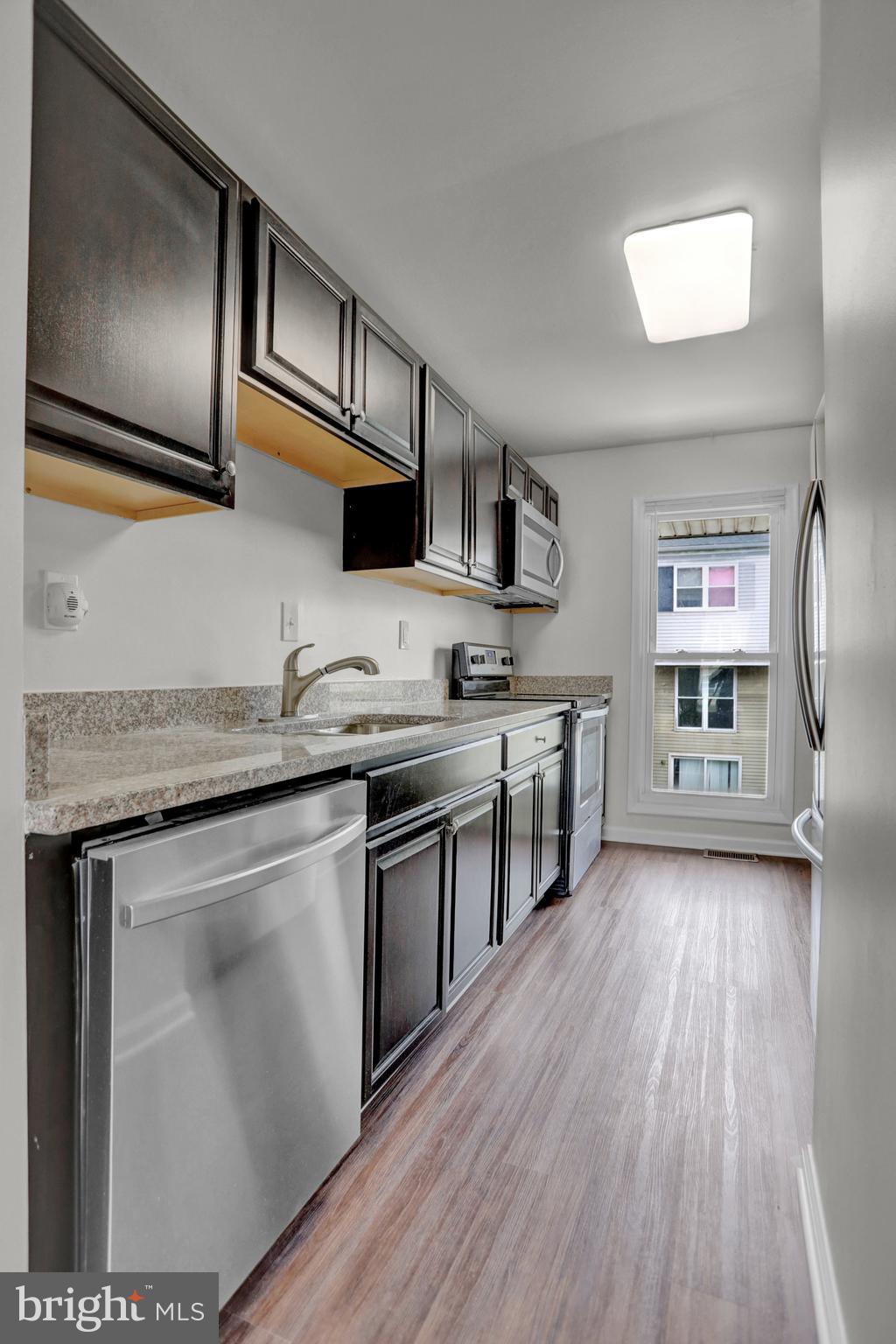 1885 Brookside Drive Edgewood, MD 21040 - Photo 21 of 45 a kitchen with stainless steel appliances granite countertop a stove a sink and a microwave