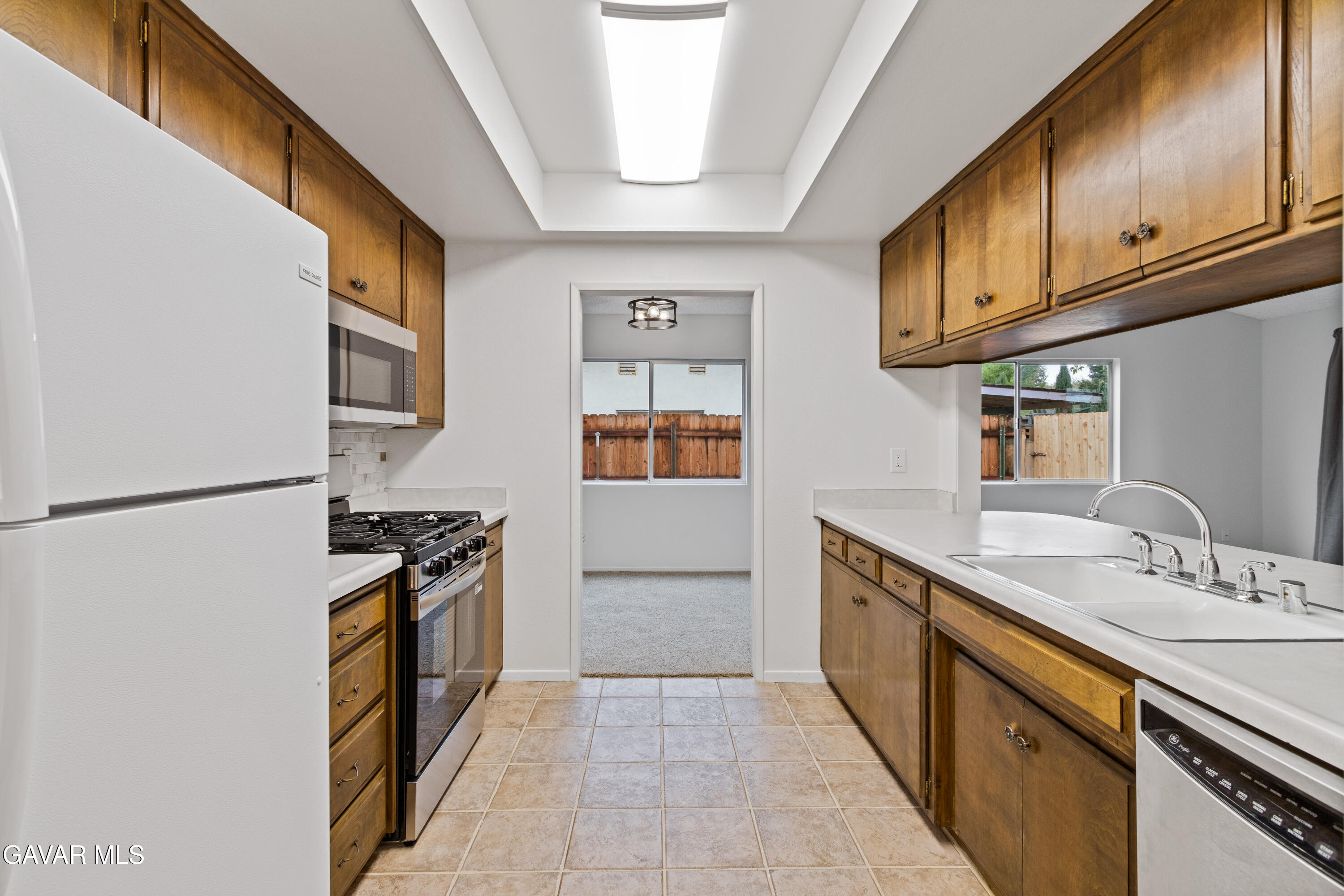 42520 55th Street West Lancaster, CA 93536 - Photo 11 of 21 a kitchen with granite countertop a sink stove and refrigerator