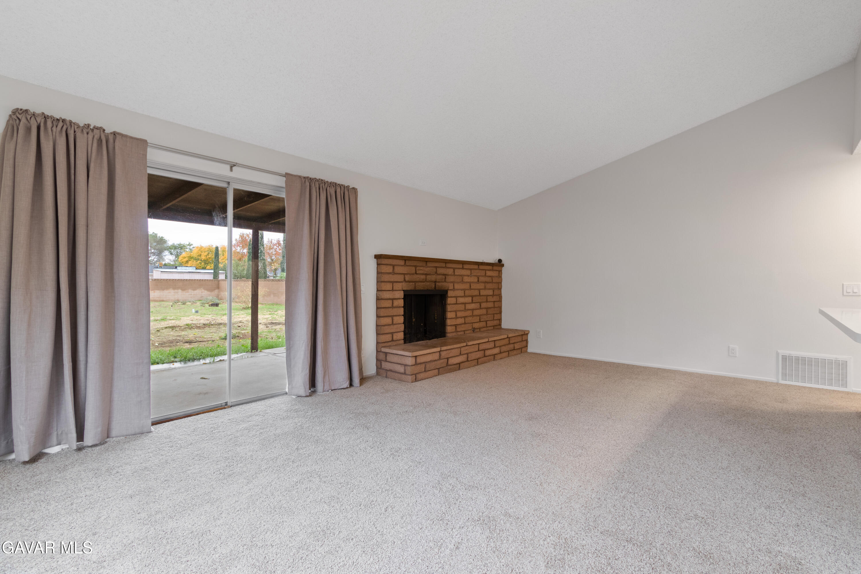 42520 55th Street West Lancaster, CA 93536 - Photo 14 of 21 an empty room with a fireplace and window