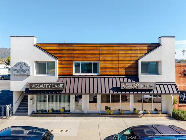 a view of a house with a backyard and sitting area