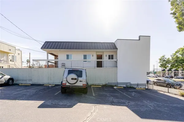 an aerial view of multiple houses with a yard
