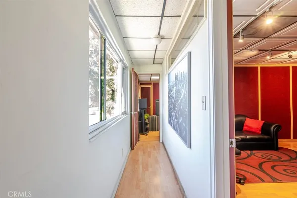 a view of hallway with furniture and a window