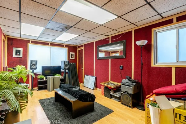 a living room with patio furniture and a flat screen tv