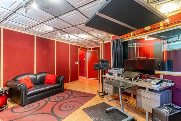 a living room with patio furniture and a chandelier