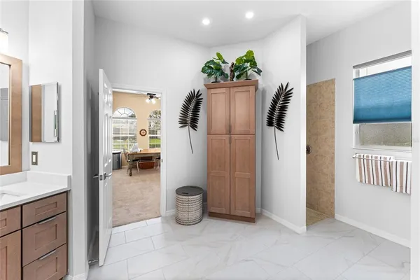 a living room with furniture a flat screen tv and kitchen view