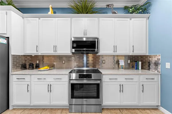 a living room with furniture a flat screen tv and a large window