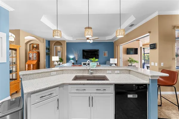 a living room with furniture a ceiling fan and a window