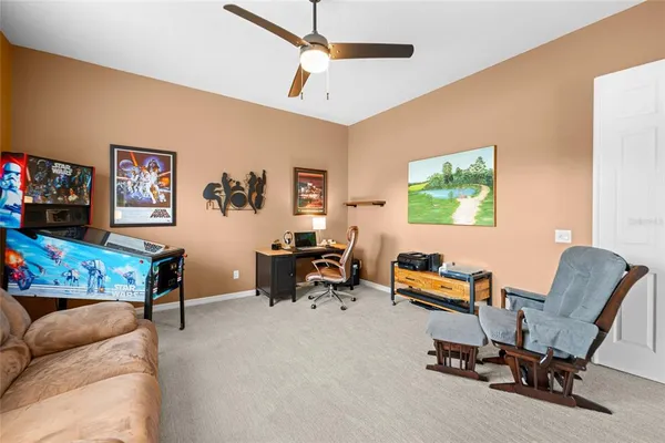 a spacious bedroom with a bed and a chandelier