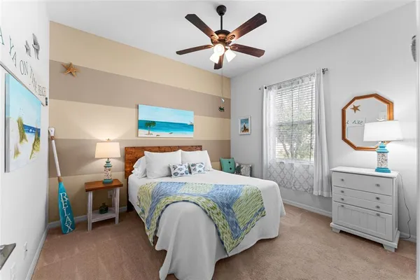 a spacious bedroom with a bed and a chandelier