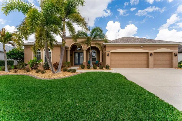 a front view of a house with a yard and garage