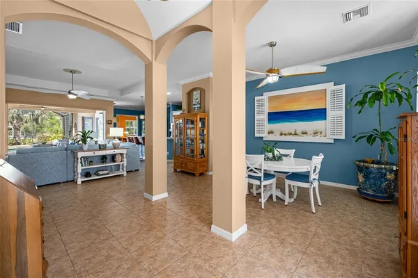 a view of a dining room with furniture and a chandelier