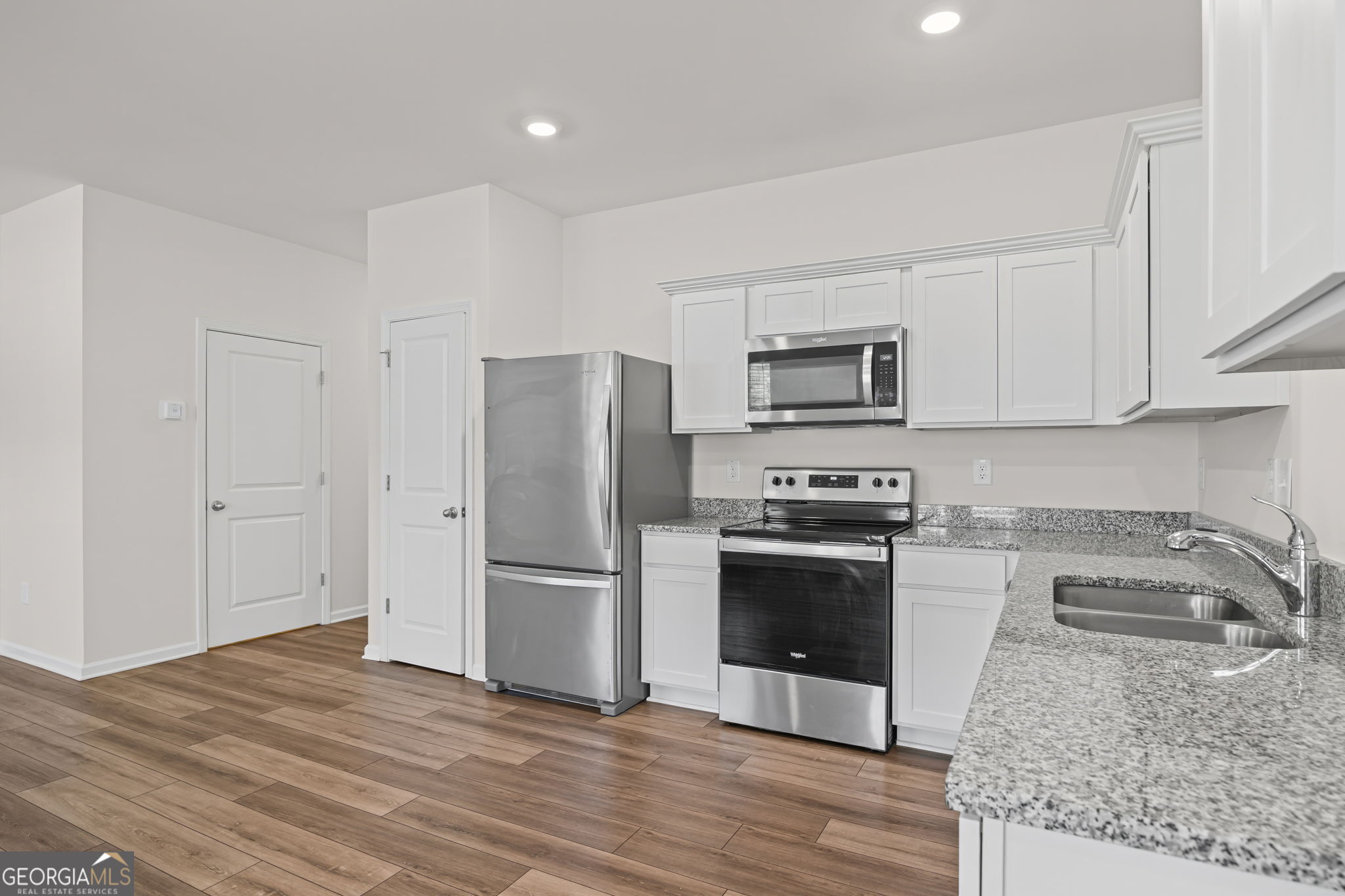 406 Kings Cross Way Cartersville, GA 30120 - Photo 11 of 28 a kitchen with granite countertop a refrigerator and a sink