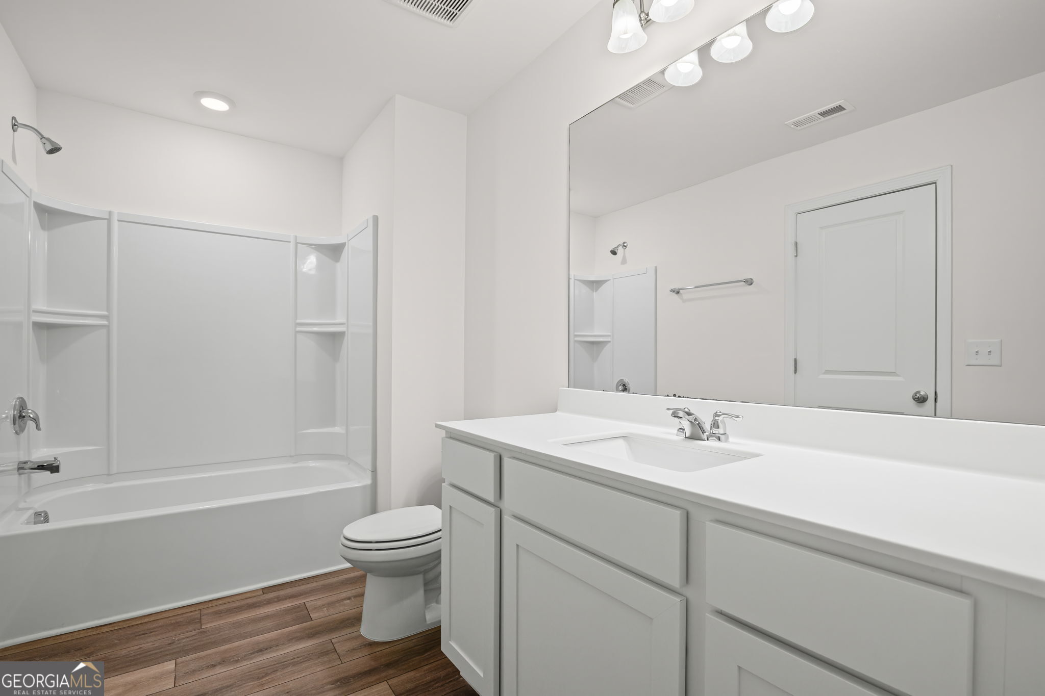 406 Kings Cross Way Cartersville, GA 30120 - Photo 19 of 28 a bathroom with a sink a toilet and a large mirror