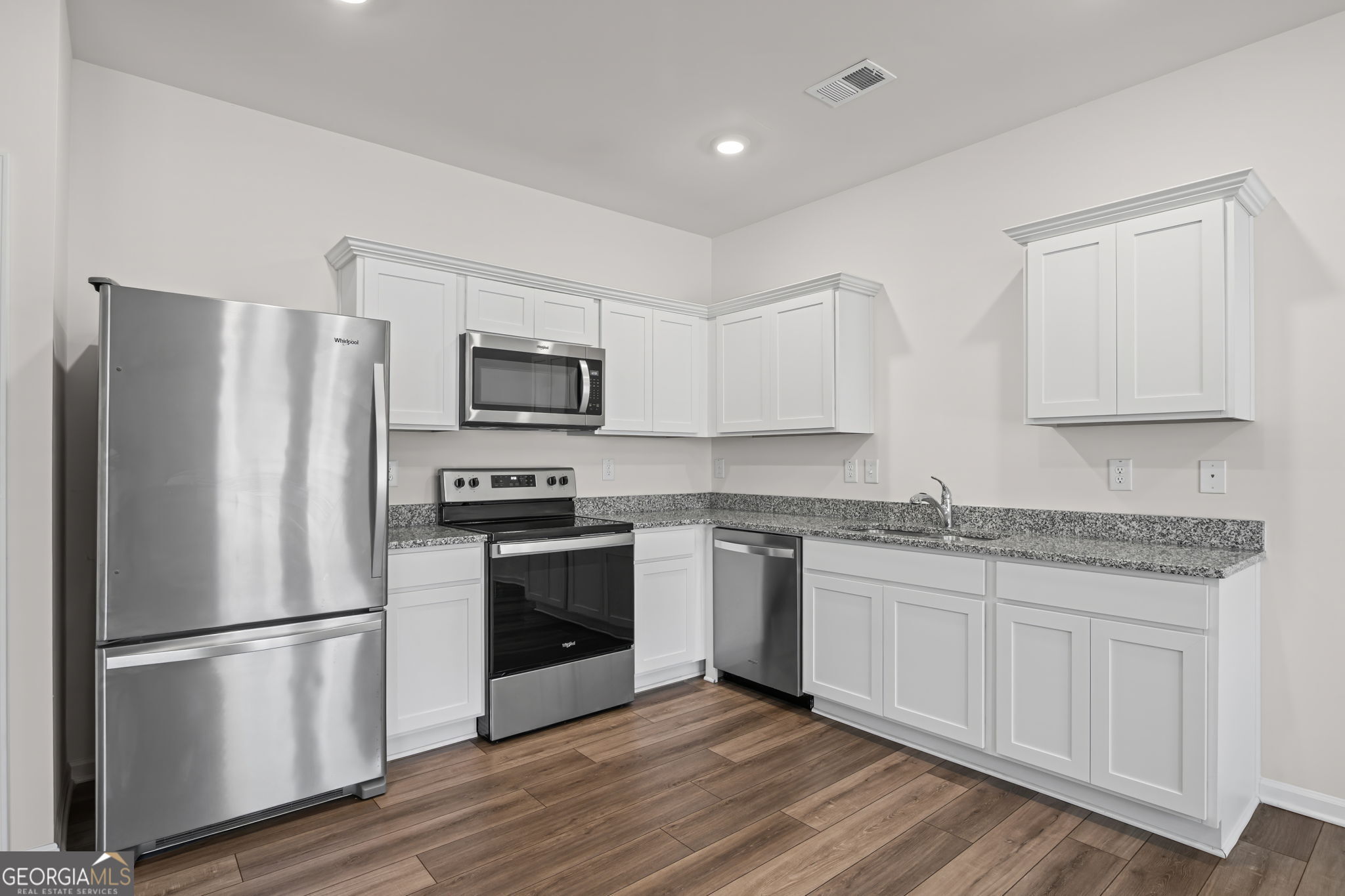 406 Kings Cross Way Cartersville, GA 30120 - Photo 10 of 28 a kitchen with stainless steel appliances granite countertop a refrigerator stove and microwave