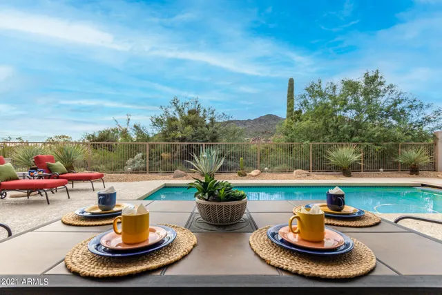 a view of a house with garden and sitting area