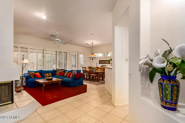 a living room with furniture and a potted plant