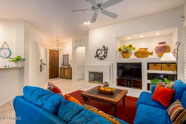 a living room with furniture kitchen view and a fireplace