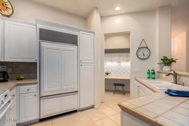 a spacious bathroom with a granite countertop sink and a mirror