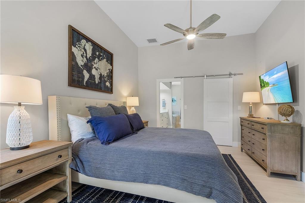 7596 San Miguel Way Naples, FL 34109 - Photo 13 of 34 a bedroom with a bed and dresser