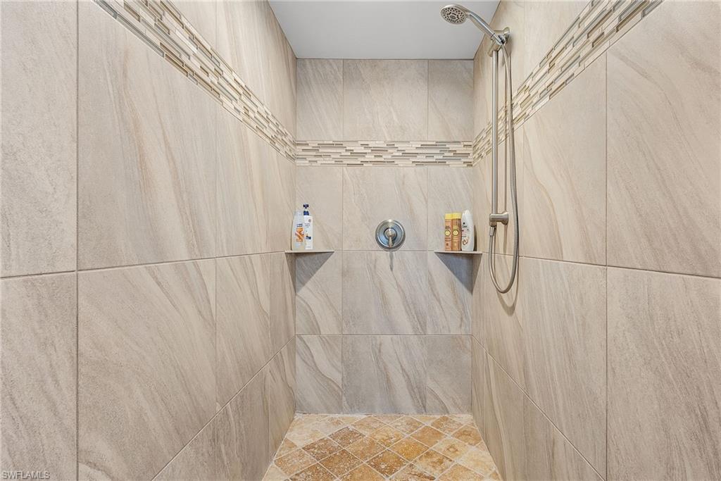 7596 San Miguel Way Naples, FL 34109 - Photo 17 of 34 a bathroom with a shower