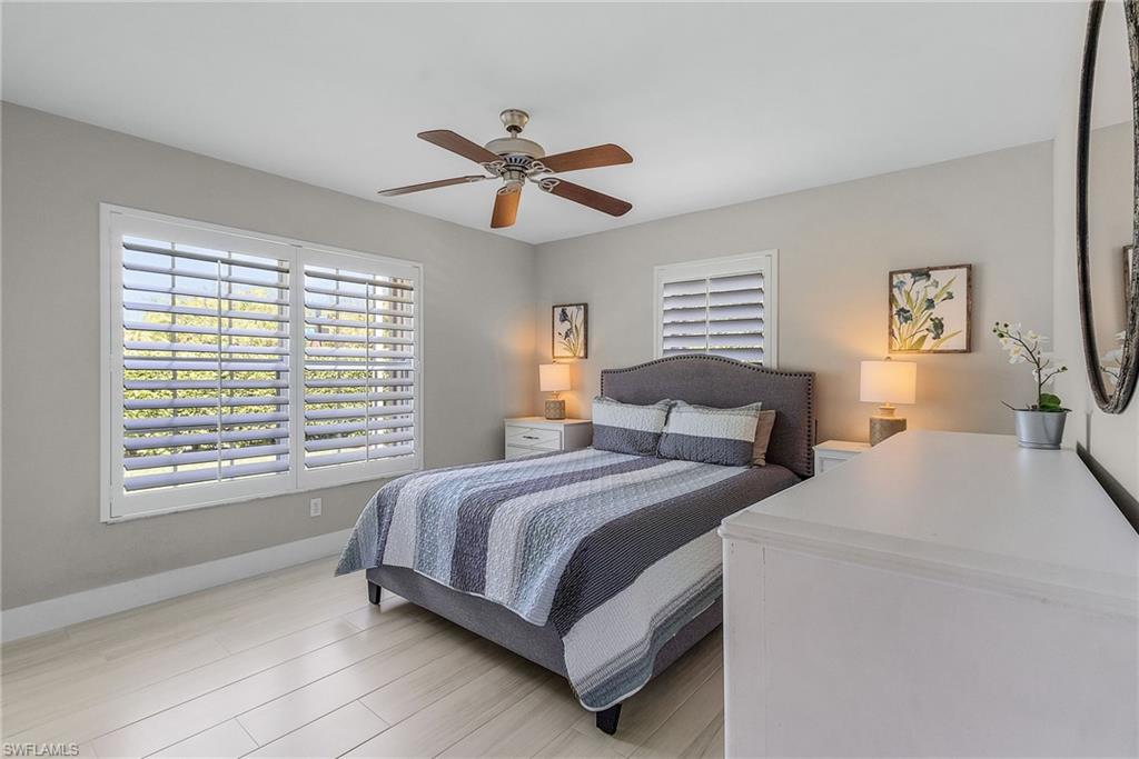 7596 San Miguel Way Naples, FL 34109 - Photo 18 of 34 a bedroom with a bed and a window