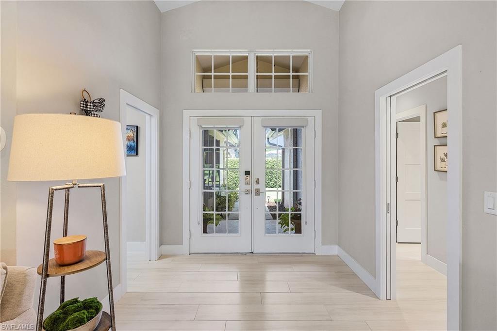 7596 San Miguel Way Naples, FL 34109 - Photo 3 of 34 a view of room with window and wooden floor