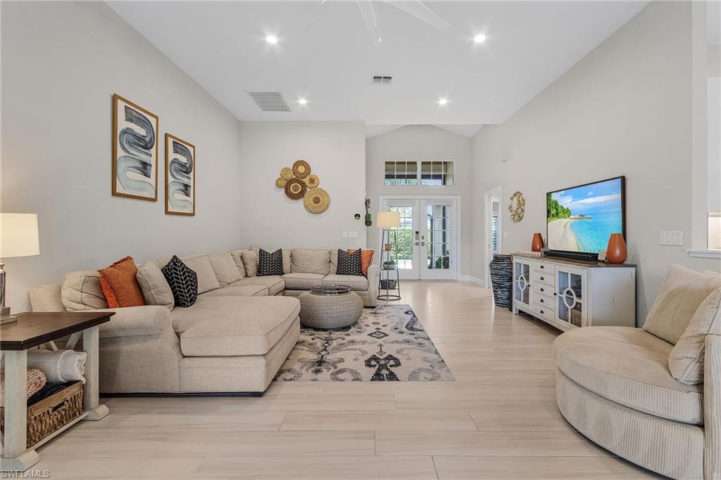 7596 San Miguel Way Naples, FL 34109 - Photo 4 of 34 a living room with furniture and a flat screen tv