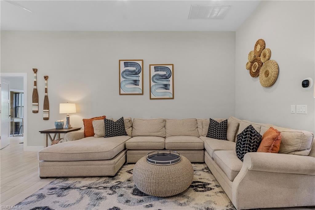 7596 San Miguel Way Naples, FL 34109 - Photo 5 of 34 a living room with furniture and a couch