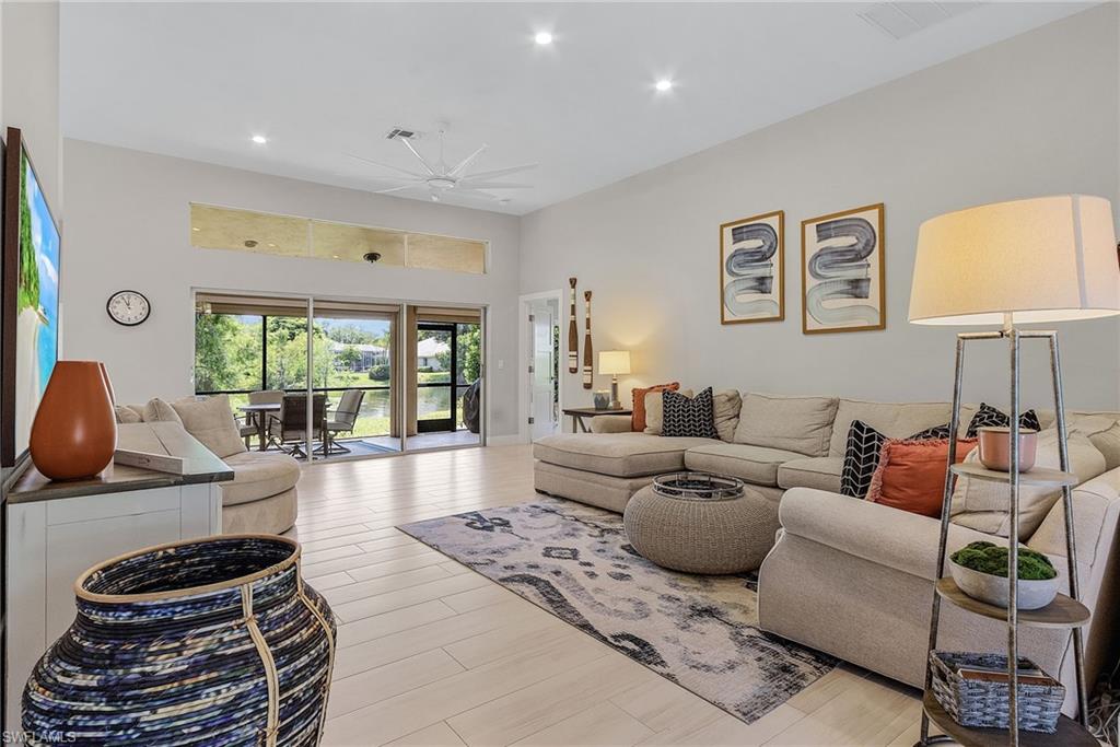 7596 San Miguel Way Naples, FL 34109 - Photo 6 of 34 a living room with furniture and a large window