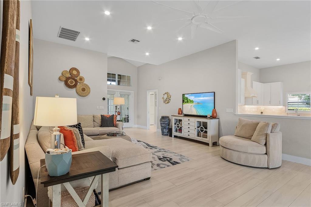 7596 San Miguel Way Naples, FL 34109 - Photo 7 of 34 a living room with furniture and a flat screen tv