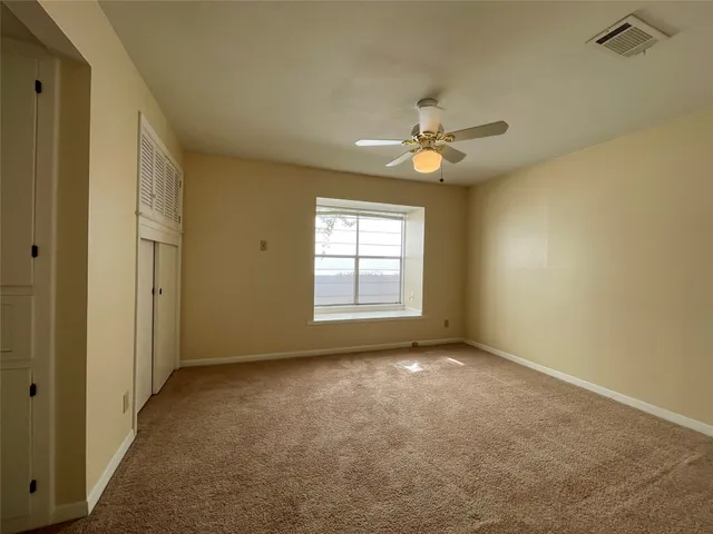 a view of room with window and ceiling fan