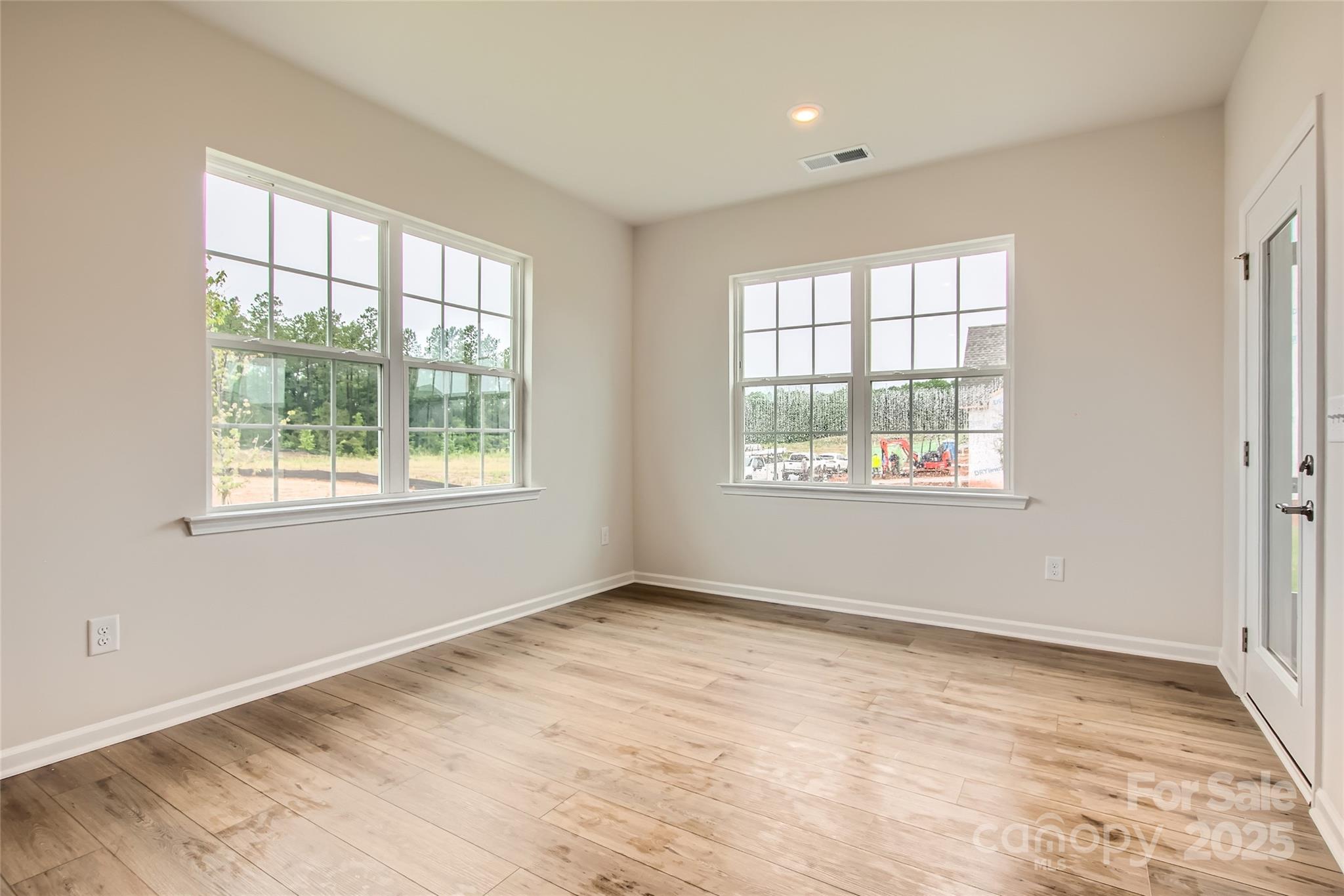 8454 Norman Frst Road Lancaster, SC 29720 - Photo 4 of 16 a view of an empty room with wooden floor and a window