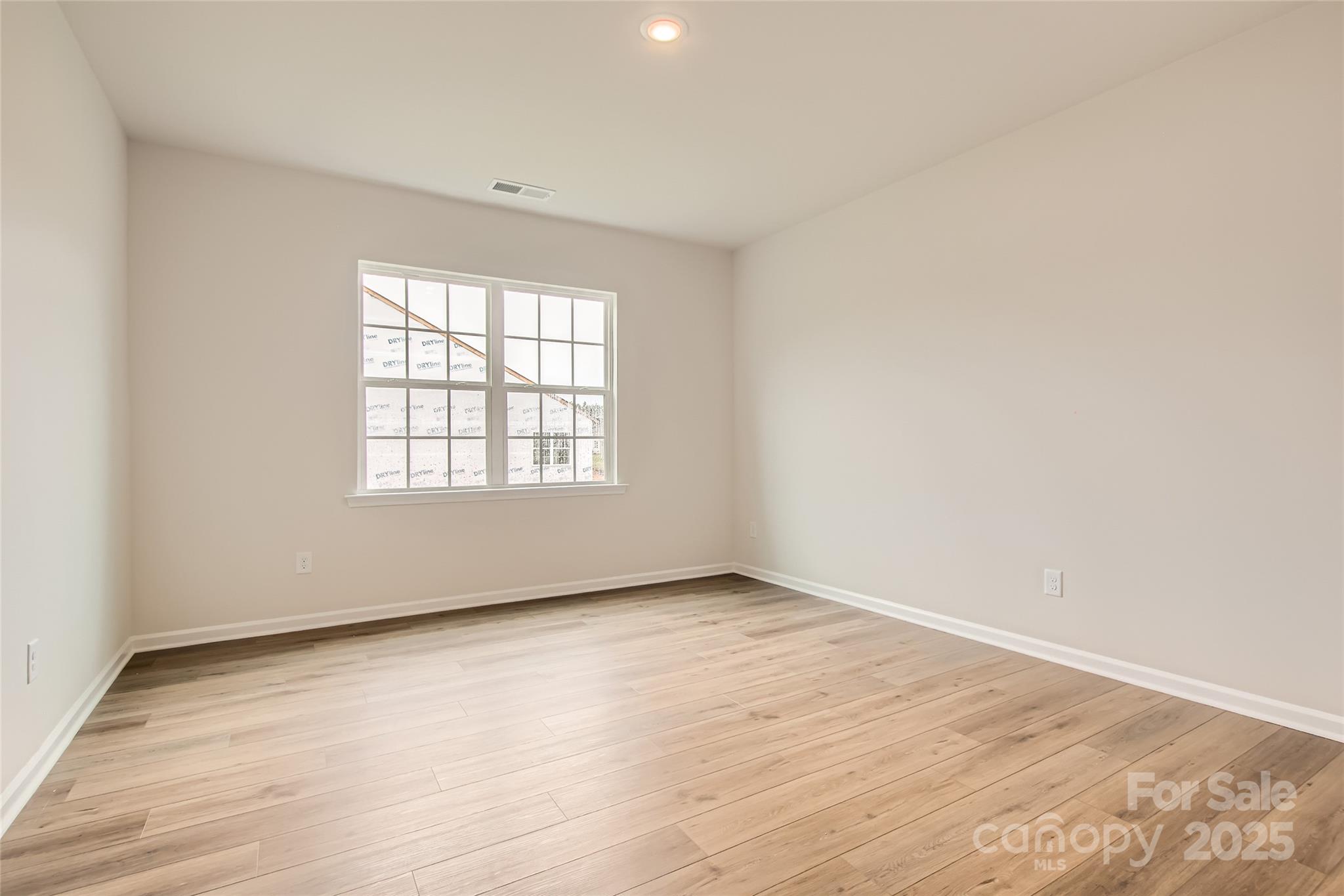 8454 Norman Frst Road Lancaster, SC 29720 - Photo 6 of 16 an empty room with wooden floor and windows
