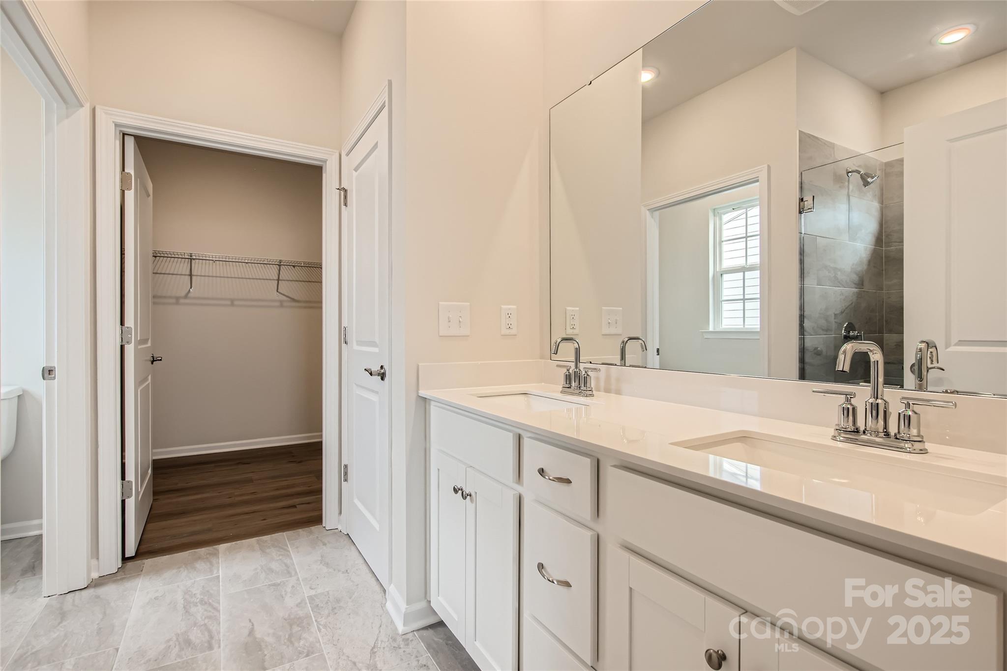 8454 Norman Frst Road Lancaster, SC 29720 - Photo 7 of 16 a bathroom with a double vanity sink and a mirror