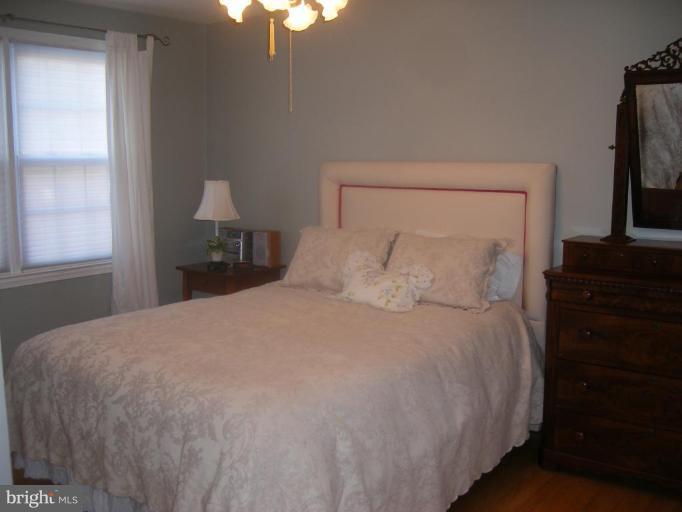 412 Dumbarton Road Baltimore, MD 21212 - Photo 3 of 11 a bedroom with a bed and a flat tv screen on dresser