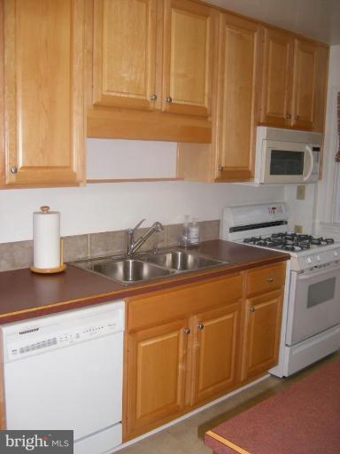 412 Dumbarton Road Baltimore, MD 21212 - Photo 8 of 11 a kitchen with granite countertop cabinets stainless steel appliances and a sink