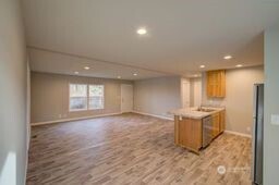 1331 Dolan Street Raymond, WA 98577 - Photo 11 of 32 an empty room with wooden floor and windows