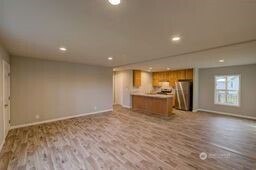 1331 Dolan Street Raymond, WA 98577 - Photo 16 of 32 a view of an empty room with wooden floor and a window