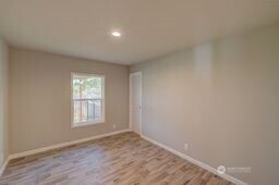 1331 Dolan Street Raymond, WA 98577 - Photo 19 of 32 an empty room with wooden floor and windows