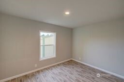 1331 Dolan Street Raymond, WA 98577 - Photo 21 of 32 a view of an empty room with wooden floor and a window