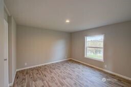 1331 Dolan Street Raymond, WA 98577 - Photo 23 of 32 an empty room with wooden floor and windows