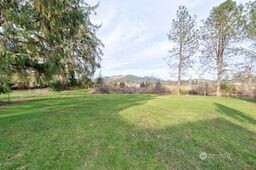 1331 Dolan Street Raymond, WA 98577 - Photo 28 of 32 a view of a field of grass and trees