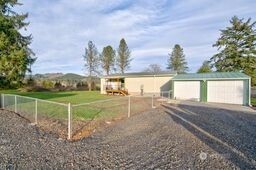 1331 Dolan Street Raymond, WA 98577 - Photo 7 of 32 a view of a lake with a big yard and potted plants