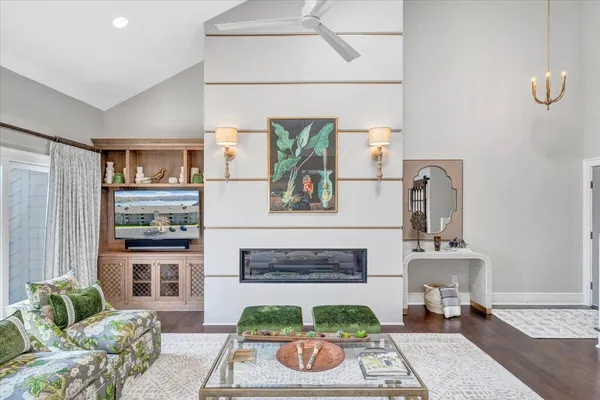 a dining room with wooden floor glass table and chairs