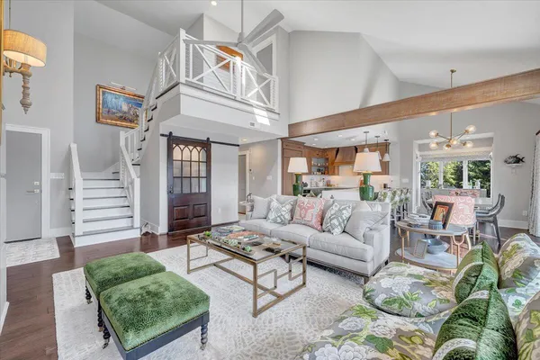 a dining room filled chandelier and wooden floor