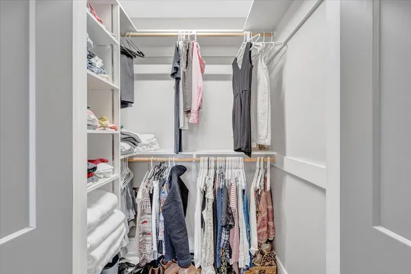 a dining room with furniture a chandelier and wooden floor